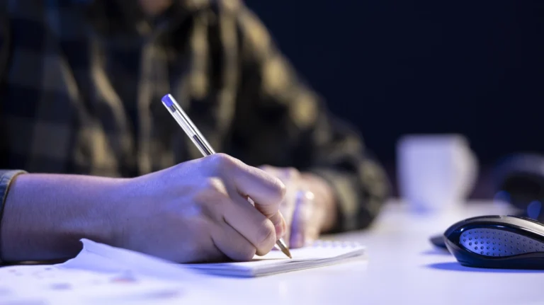 person-making-notes-with-pen-paper person-making-notes-with-pen-paper